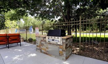 Picnic And Bbq Area at Woodland Hills Apartments, Colorado Springs, Colorado